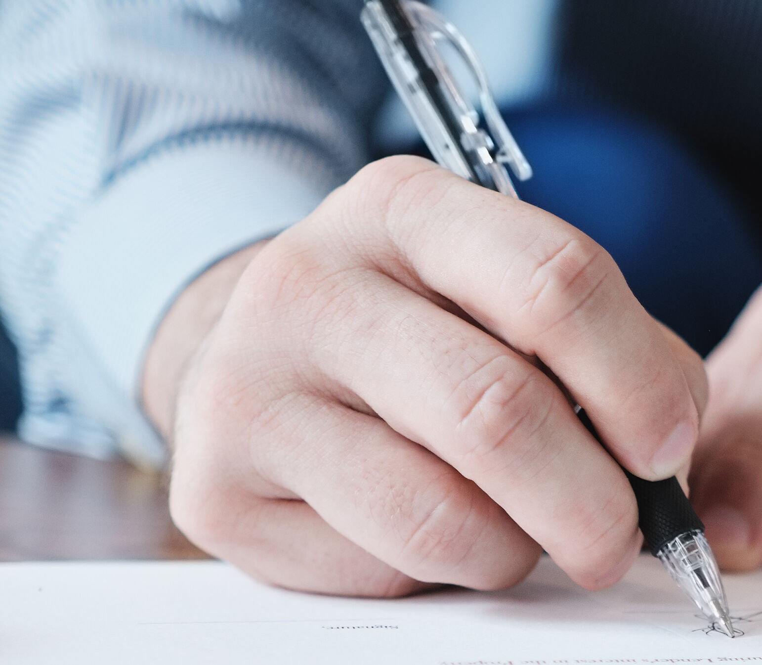 Closeup of Manager Signing Contract In Business Office